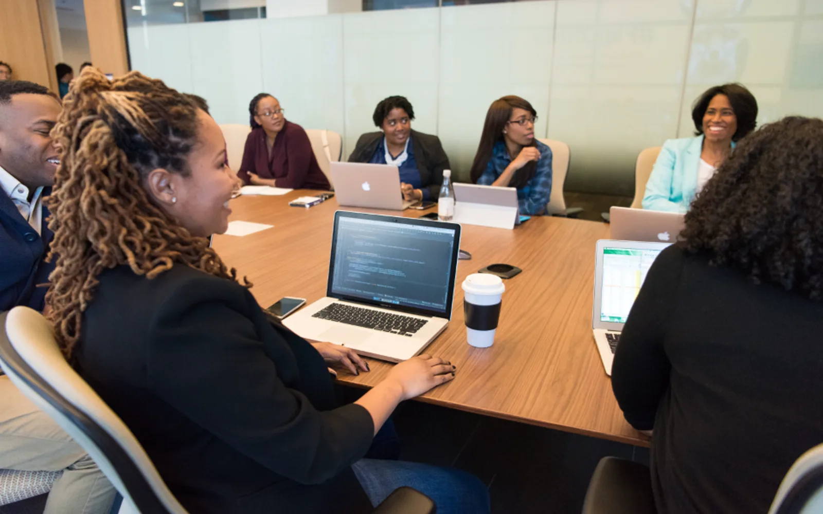 A team around a conference table with laptops