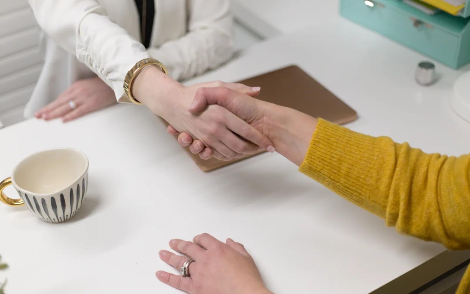 A handshake across a desk